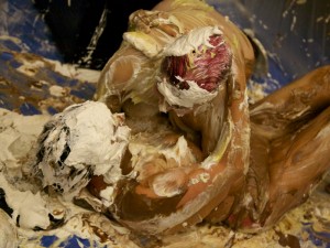 Thoroughly pied and covered, Mistress Messiér and Maya Kralovna wrestle playfully in the goop at the Debauchery 2013 messyplay demo.